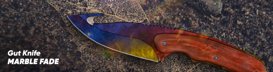 CS2 Marble Fade Gut Knife skin with vibrant red, blue, and yellow marbled swirls and a polished blade.